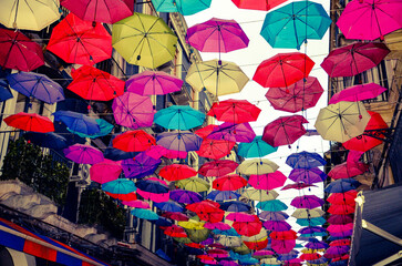A historic street full of charming restaurants withcolorful umbrellas in Catania