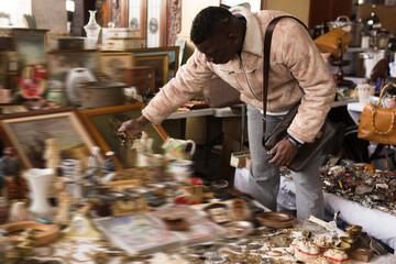 Man chooses antiques on the flea market
