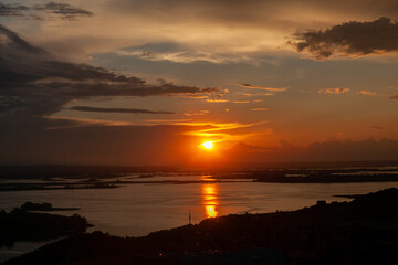 A breathtaking sunset paints the sky with vibrant colors as it reflects on the calm waters surrounding Sviyazhsk.