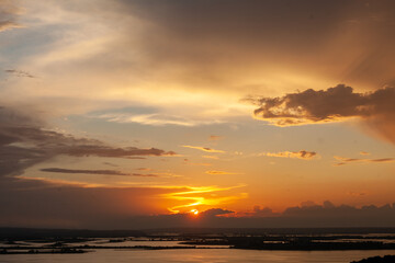 Vibrant colors paint the sky as the sun sets over Sviyazhsk, casting reflections on the calming waters below.