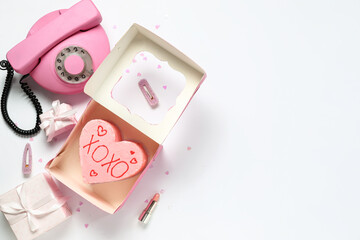 Heart-shaped bento cake with gift boxes and retro telephone on white background. Valentine's Day celebration