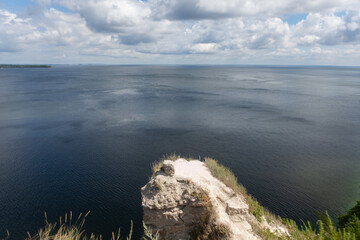 Stunning vista overlooking the Vilga River where calm waters meet dramatic clouds, embodying serene natural splendor