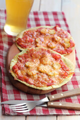 Sausage and tomatoes tortilla pizzas with beer