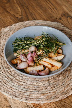 Hot chips in a bowl with herbs and garlic