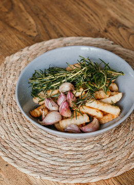 Looking down at af resh bowl of hot chips cooked with herbs and garlic