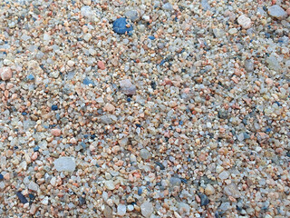 Beautiful sand in the summer day. A little stones and sand on the beach near a sea.