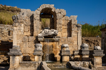 Naklejka premium Rows of columns in Perge, Antalya, Turkey. Remains of colonnaded street in Pamphylian ancient city.Rows of columns in Perge, Antalya, Turkey. Ancient Kestros Fountain. Aksu, Antalya