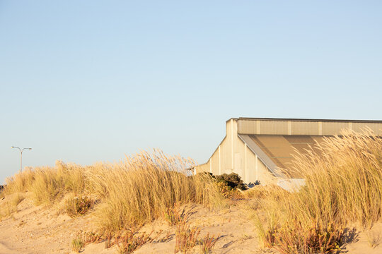 old industrial building at the port obscured in sand dunes