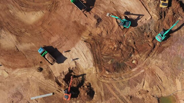 Aerial view road motor grader flatting dirt road surface, Motor grader road construction grader industrial machine construction site new road, Aerial view group excavator working on construction site.
