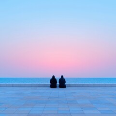 Two figures sit facing a serene seascape at dawn, enjoying a tranquil moment.