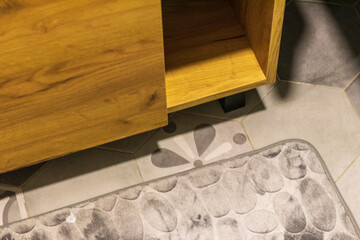 Shot of the mat on the tile floor of the bathroom. Concept