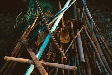 Old wooden fishing net with metal hook, ready for a day on the water