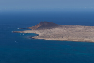 View of La Graciosa Island in the Canary Islands and Playa Francesa and the Volcanic mountain in the background.