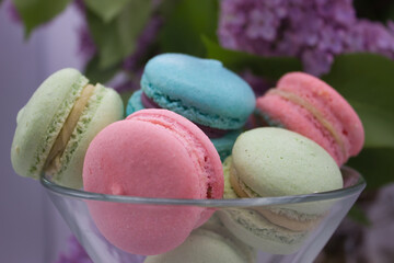 Close-up of colorful macarons with lilac background
