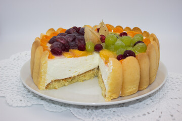 Fruit-adorned Charlotte cake with layers.