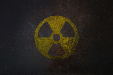 Radioactive (ionizing radiation) round yellow and black danger symbol painted on a massive rusty...