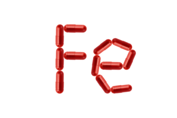 Creative idea for iron anemia concept. Supplement of ferritin in red capsule isolated on transparent background. Capsule representing iron supplementation for treating iron deficiency and anemia.