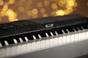 Piano against blurred lights, closeup. Bokeh effect