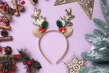 Beautiful reindeer headband and Christmas decor on lilac background, flat lay