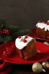 Piece of traditional classic Christmas cake and decor on wooden table