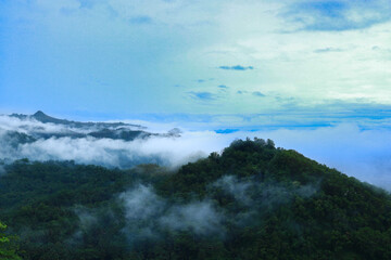 Obraz premium Indonesia, December 1, 2024. hills covered in mist.
