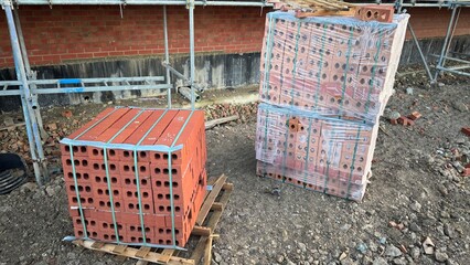 Two Pallets of Red Bricks at Construction Site