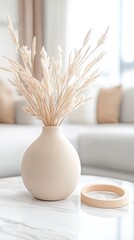 Naklejka premium A modern living room with white walls, a sofa, and a coffee table. The focus is on the elegant beige ceramic vase in front of it.