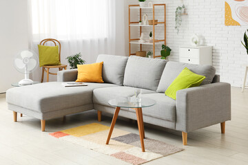 Fototapeta premium Modern electric fan on coffee table at home