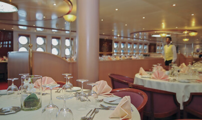 Formal and elegant ocean view dining room restaurant onboard historic luxury cruiseship or cruise...