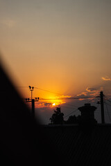 Sunset over the roof of the house