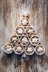 Mince pies christmas  tree on a wooden background, top view. Christmas dessert and decoration