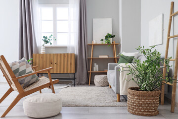 Armchair, sofa, shelving unit and poufs in interior of living room