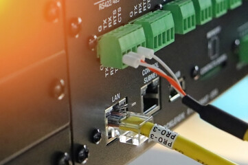 Connection of electrical modules using insulated mounting wires. Close-up. Soft focus.Sunflare. 