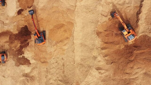 Aerial view road motor grader flatting dirt road surface, Motor grader road construction grader industrial machine construction site new road, Aerial view group excavator working on construction site.
