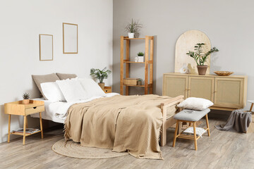 Interior of bedroom with soft bench, shelf unit and plants