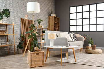 Interior of modern living room with sofa, shelf units and plants