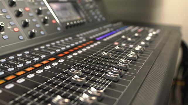 Sound mixing console with moving faders increasing sound. Professional device with equalizers processes and mixes various audio signals