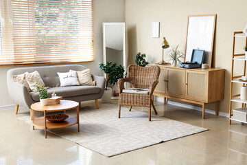 Interior of living room with sofa, armchair and commode