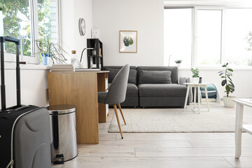Interior of living room with modern grey sofa and workspace