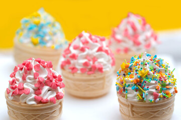 Marshmallows in the form of Ice cream in a waffle cup, decorated with sprinkles.