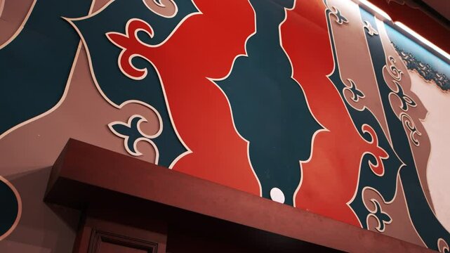 Tatar pattern with shapes decorates wall of concert hall. Large symbols above room entrance symbolize abstract and cultural concepts