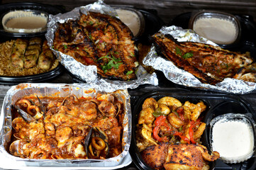 Seafood cuisine of Mixed fish fillet, shrimps, squid, squid eggs, fish roe, mussels, clams, crabs, red sauce, herbs, Tilapia, Mullet Sinjari Fishes with vegetables, red fish rice and Tahini salad