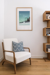 Modern living room corner with stylish chair and framed art