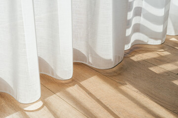 Soft sunlight streaming through sheer curtains in a modern interior space