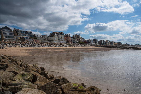 Typical houses by the beach in the town of Agon in Normandy, France