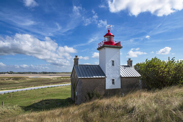 Red and white lighthouse at the Pointe d'Agon in Normandy, France