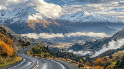 A mountain ridge road with breathtaking views of snow-capped peaks and valleys below, with clouds drifting through the scene.