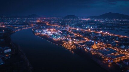 Fototapeta premium Stunning Aerial Perspective of a Vibrant Night Cityscape in Thailand Under a Starry Winter Sky
