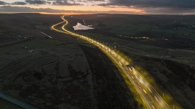 Aerial hyper-lapse video over Scammonden bridge in Kirklees, west Yorkshire showing the traffic and the countryside landscape at sunset. 