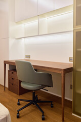 A modern workspace featuring a stylish desk and a cozy chair to enhance productivity and comfort